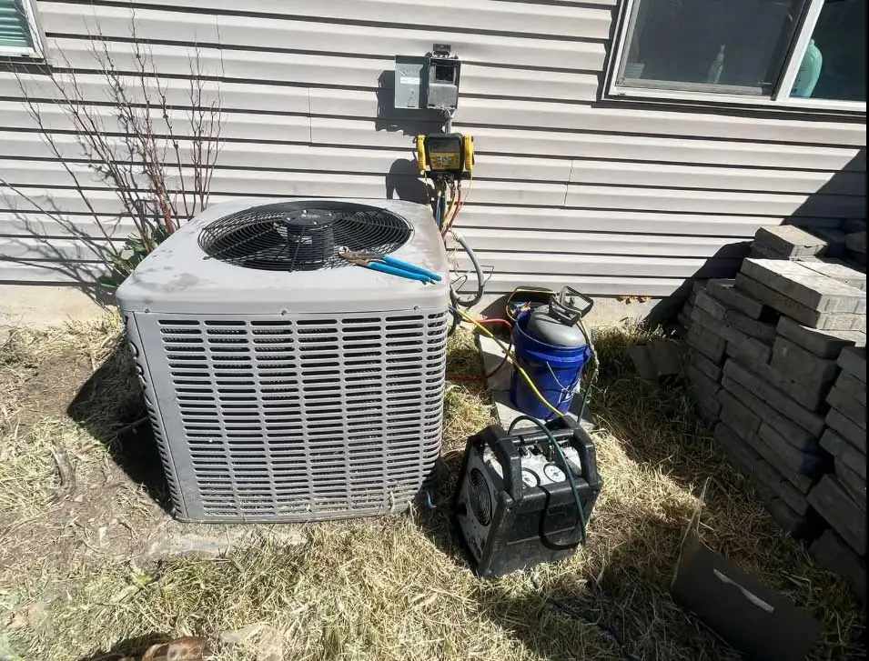 Air conditioning unit being serviced